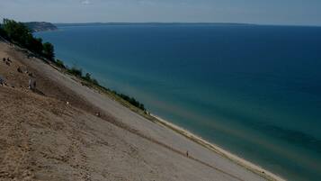A coastal landscape with a sandy beach and a clear view of the sea.