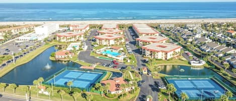 A resort with multiple buildings, a beach, and a marina.