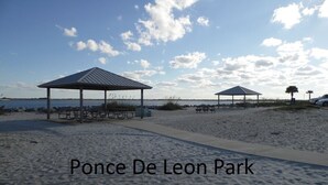 A beach with picnic shelters and a clear sky. - Penthouse Suite! Spacious End Corner Unit! 3Bedroom 3 Bath! New Pool 2024 (Daytona Beach)