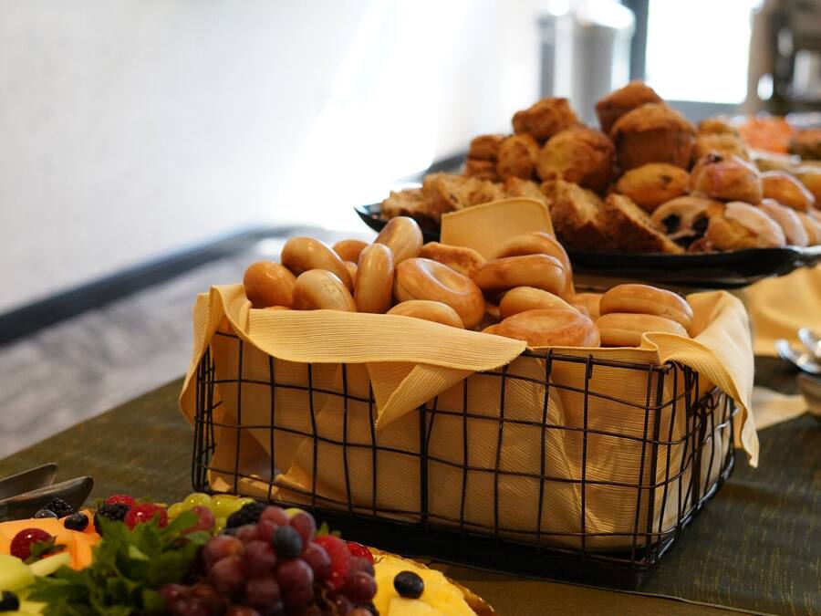 A buffet table with various baked goods and a fruit platter.