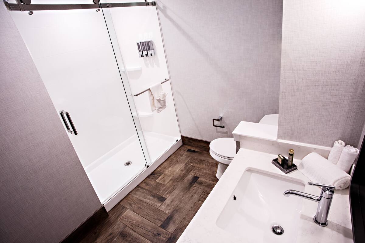 deluxe room, 2 queen beds | bathroom | designer toiletries, hair dryer, towels