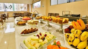 A buffet with various fruits and desserts.