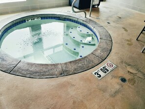 A small indoor pool with a depth marker of 3 feet 9 inches.