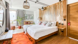 A modern bedroom with a wooden bed, a desk, a large window, and a potted plant. - qema Arequipa (Arequipa)