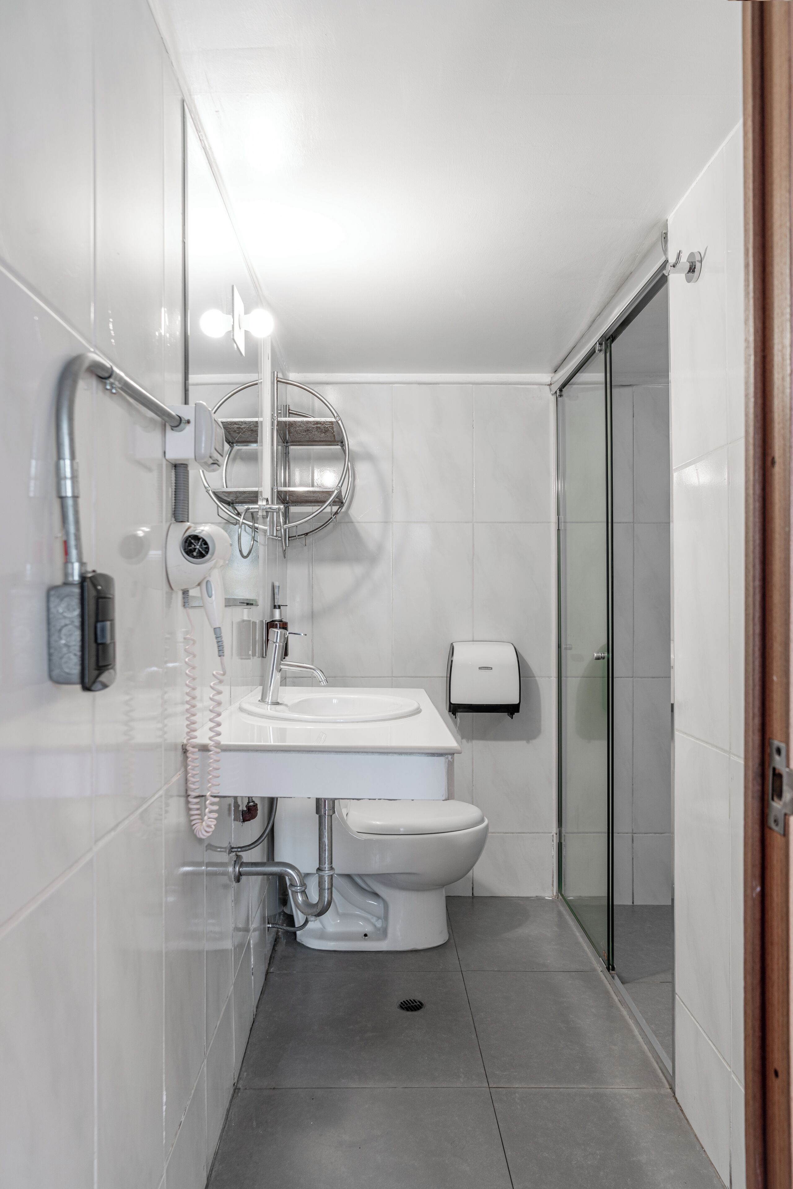 A modern bathroom with a toilet, sink, and shower.