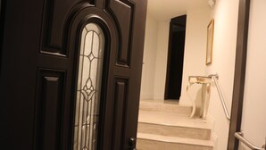 A dark wooden door with a glass panel and a metal handle.