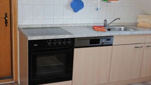 A kitchen with a dishwasher, oven, and a sink. - Apartment 1 "Auerhahn" up to 4 persons + cot - dog allowed (Wernigerode)