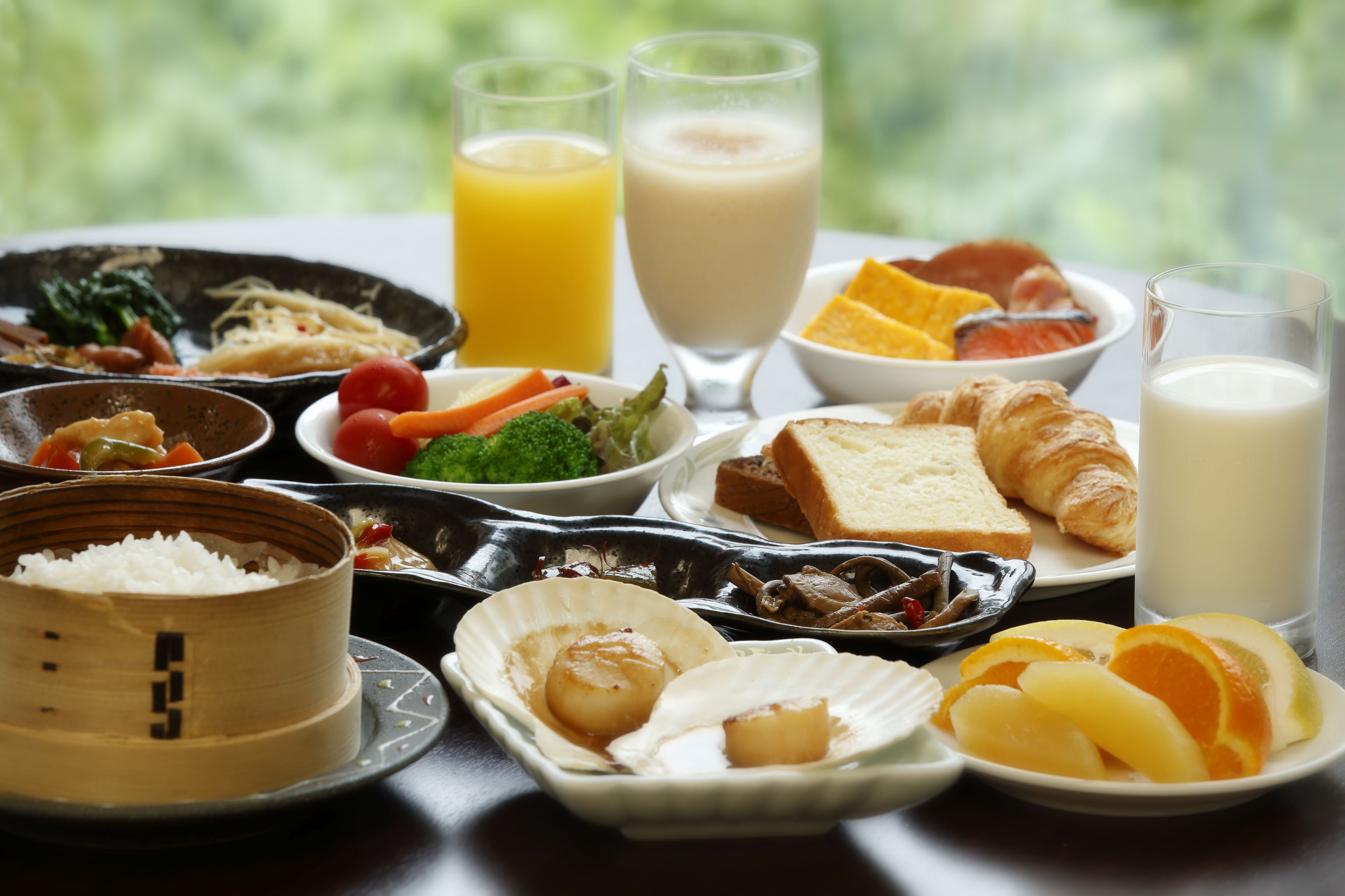 A variety of dishes including rice, seafood, and fruits, suggesting a diverse meal option.