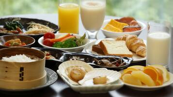 A variety of dishes including rice, seafood, and fruits, suggesting a diverse meal option.