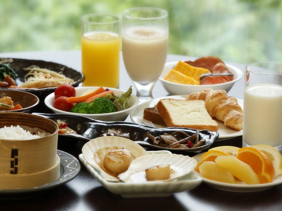 A variety of dishes including rice, seafood, and fruits, suggesting a diverse meal option.