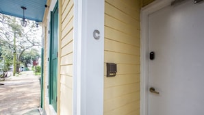 A house with a porch, a door, and a mailbox.