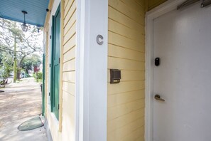A house with a porch, a door, and a mailbox.