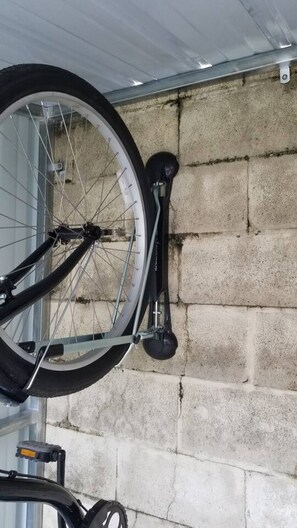 A bicycle leaning against a concrete wall.