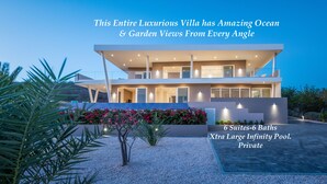 A luxurious villa with ocean and garden views, 6 suites, and a large infinity pool.