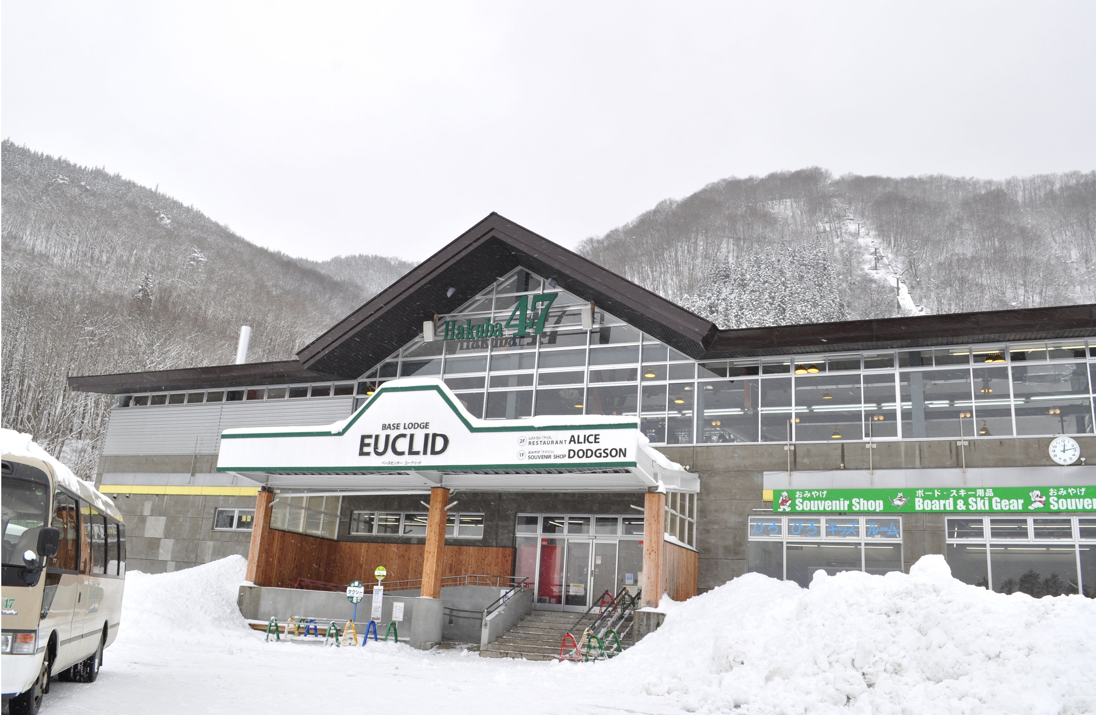 A hotel named "Base Lodge Euclid" with a sign indicating "Restaurant Alice" and "Souvenir Shop."