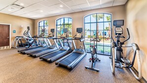 A gym with treadmills, elliptical machines, and stationary bikes.