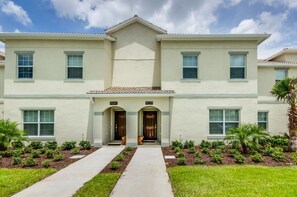 A two-story building with a symmetrical facade, numbered units 9041 and 9039, and a central entrance with a small porch. - Ev230259 - Champions Gate Resort - 4 Bed 3 Baths Townhome (Davenport)