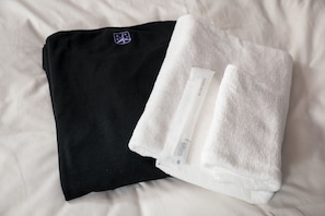A black and white towel on a bed.