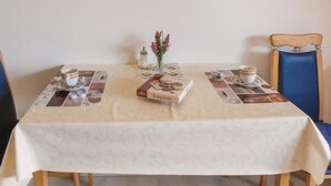 A table set with a book, a vase with flowers, and a cup. - 1 bedroom cozy apartment in Medebach-Düdinghausen (Medebach-Düdinghausen)