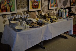 Une table de buffet proposant divers plats, couverts et une pancarte indiquant « Buffet de gala ».