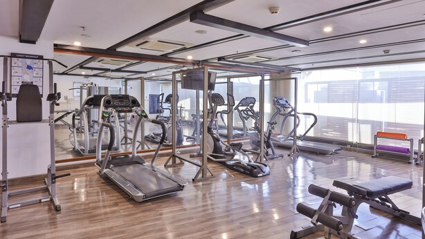 A gym with treadmills, elliptical machines, and weight equipment. - Avari Xpress Multan (Multan)