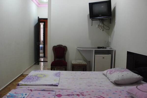A bedroom with a bed, a desk, a chair, and a television. - Lux Batumi (Batumi)