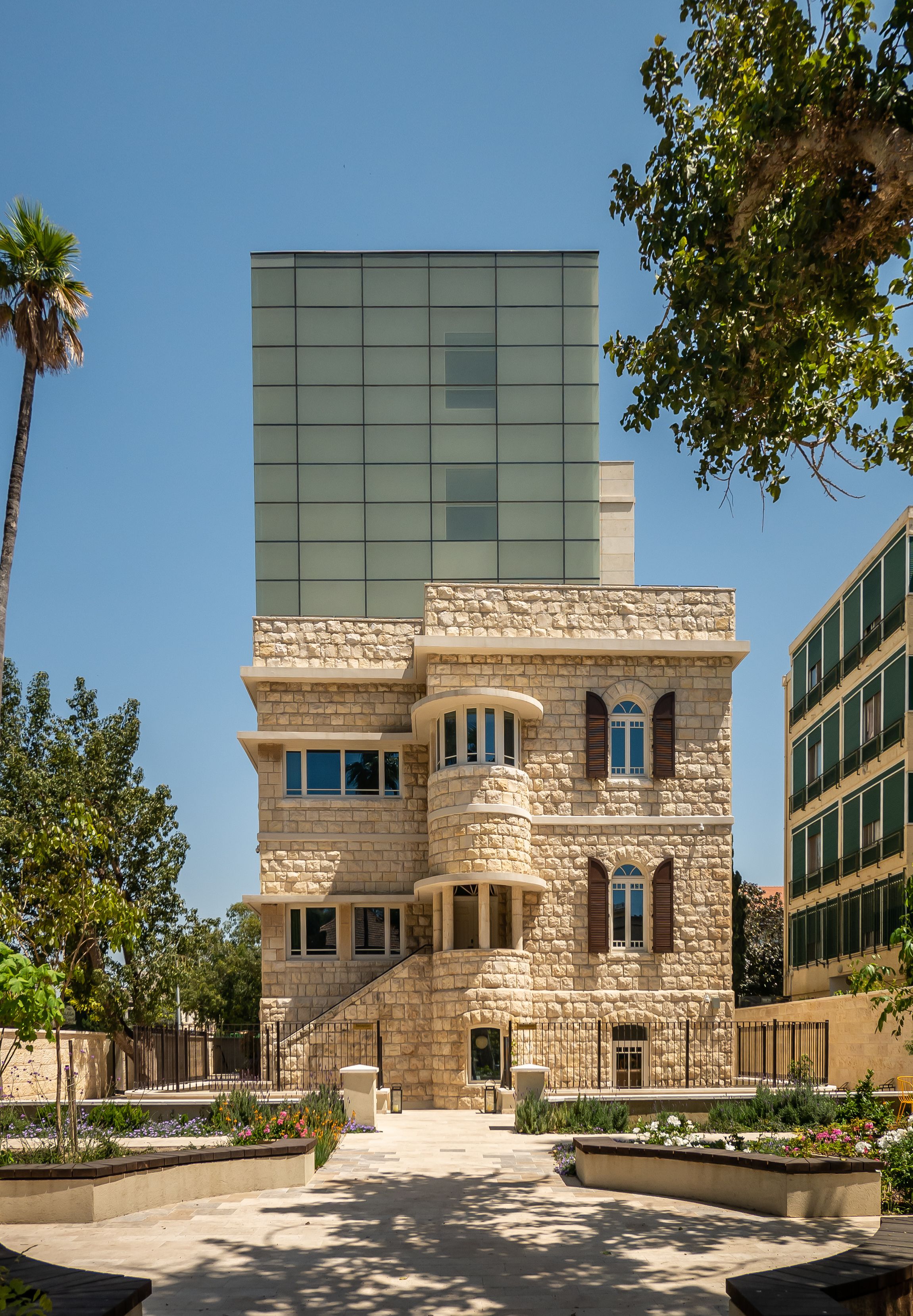 A building with a stone facade and a modern glass section.