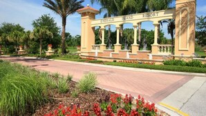 A sign for Emerald Island Resort with a classical architectural design, featuring columns and statues. - Ov2348 - Emerald Island Resort - 5 Bed 4.5 Baths Villa (Davenport)
