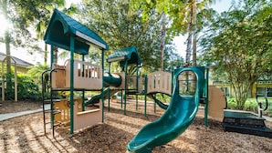 A playground with a slide, climbing structures, and a playhouse. - Ov2348 - Emerald Island Resort - 5 Bed 4.5 Baths Villa (Davenport)