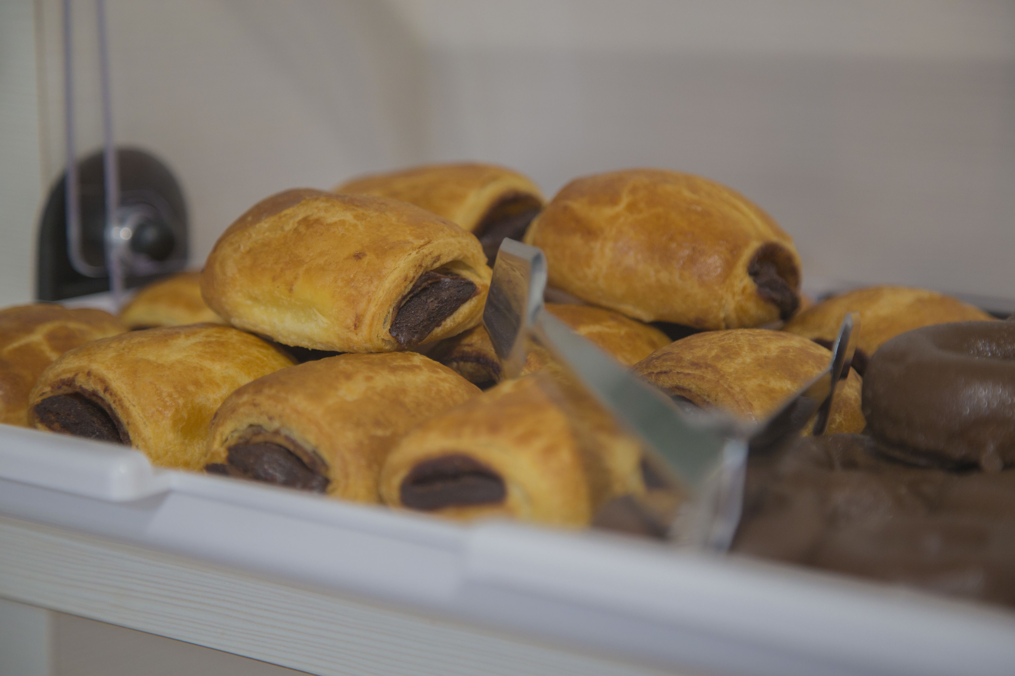 A display case containing various baked goods, likely pastries or desserts.