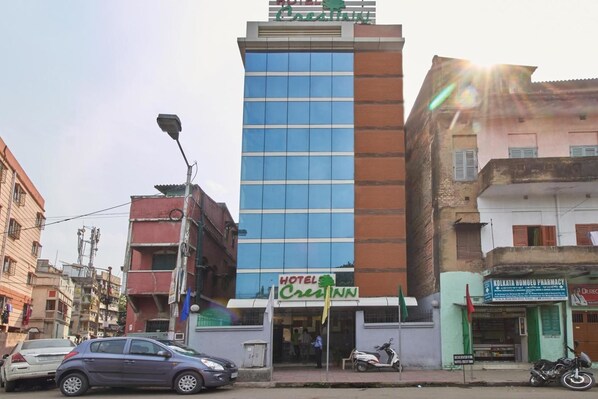 A hotel with a modern facade, a sign indicating it is a hotel, and a visible entrance. - Hotel Crest Inn (Kolkata)