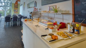 A breakfast buffet with various food items and a chalkboard menu.