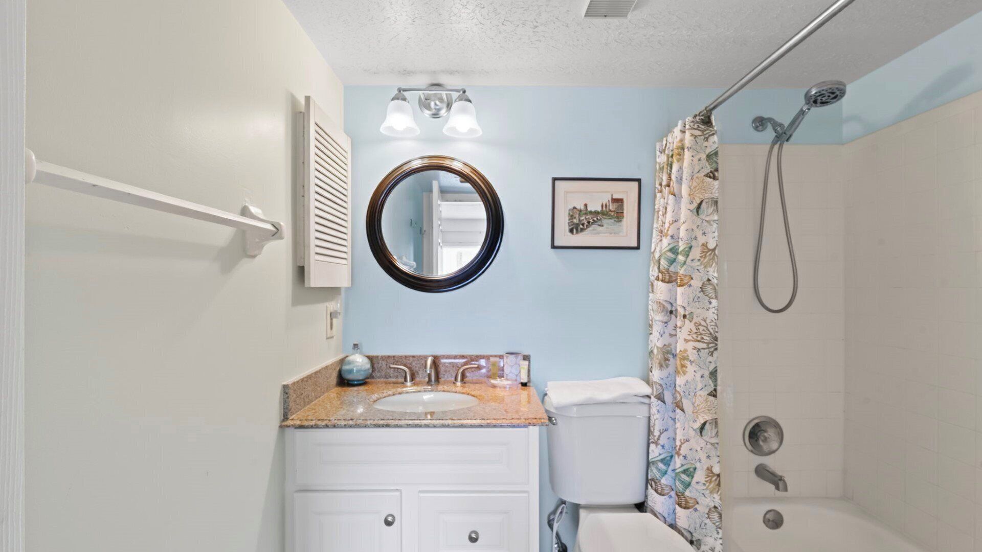 A bathroom with a sink, toilet, and shower.