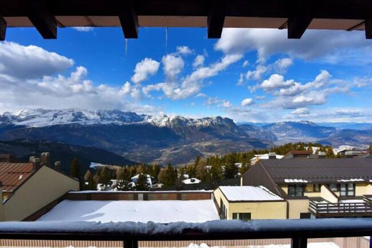 A mountain view with snow-covered peaks and a clear sky.