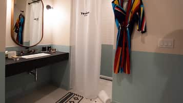 A bathroom with a sink, mirror, and a shower curtain labeled "Texican Cove".