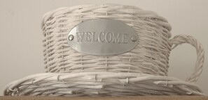 A wicker basket with a metal plate that reads "WELCOME". - Gordon House (Wimborne)