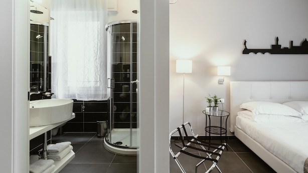 Une salle de bain moderne avec une douche à parois de verre, un lavabo blanc et un miroir.
