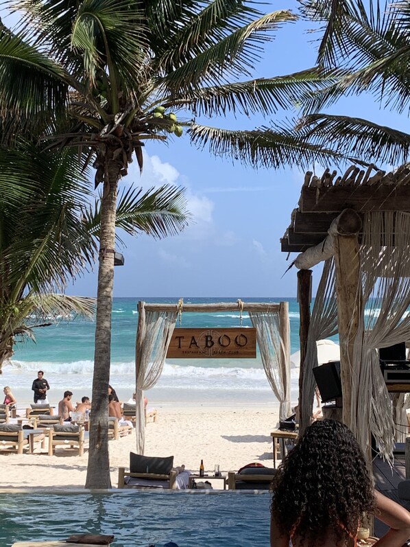 Relax at the beachside TABOO, where a thatched structure offers a casual dining experience.