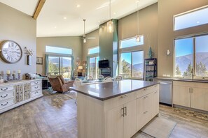 Enjoy a spacious living area with a large island for dining and workspace, complemented by a sleek kitchen with dishwasher.
