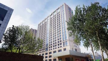 A multi-story hotel with a modern facade, large windows, and a flat roof.