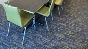 A conference room with a long table and chairs, a flat-screen TV, and framed artwork on the wall. - Holiday Inn Express & Suites Junction by IHG (Junction)