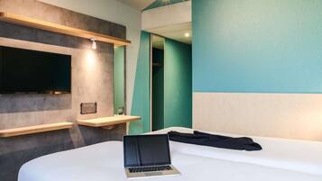 Hypo-allergenic bedding, desk, laptop workspace, blackout drapes