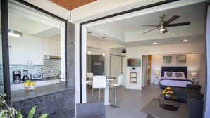 A modern interior with a kitchen, dining area, and a bedroom. - Casa Isacamil - Impeccable Views, Contemporary, Rooftop Pool, Proximity to Town (5 de Diciembre)
