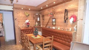 A cozy dining area with a wooden table, chairs, and a bench. - BEAUTIFUL CHARMING SAVOYARD CHALET ,, 3 * WIFI   (Villard-sur-Doron)