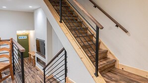 A staircase with wooden steps and metal railings, leading to an upper floor. - Walk to Skiing, Hiking and Main Street! (Breckenridge)