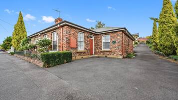 Stunning two-story building with a central entrance and beautifully manicured grounds.