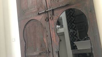 A large wooden door with intricate carvings and a metal latch.