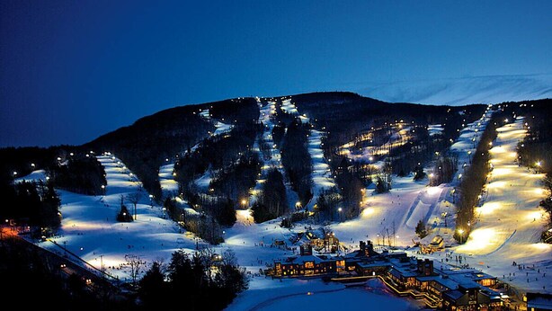 A snow-covered ski resort at night with illuminated ski slopes and buildings. - Wachusett Mountain Getaway, Lake Adjacent Home! Near 1761 Old Mill and Trails! (Westminster)