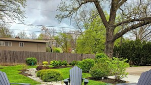 An outdoor seating area with Adirondack chairs and a fire pit. - Serene Retreat Awaits You!  (Highland Park)