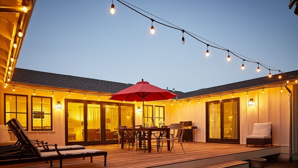 An outdoor deck with a dining table, chairs, and a red umbrella. - Modern Sonoma Farmhouse, Hot Tub, Close to Historic Sonoma  Square (Sonoma)